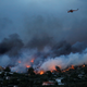 A firefighting helicopter flies over Rafina.